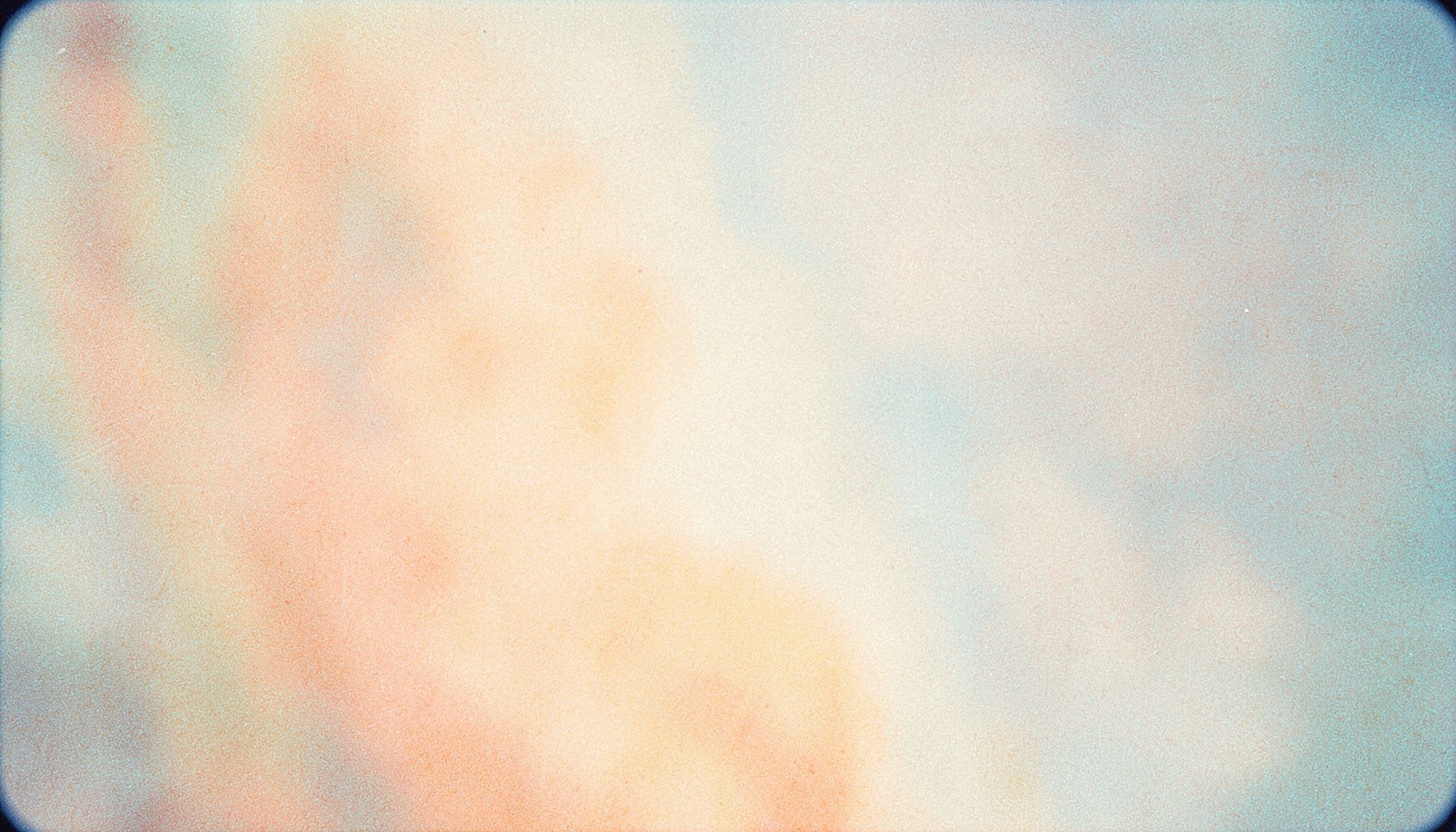 Warm peach and cream tones blending softly, calm and supportive atmosphere on grainy film.