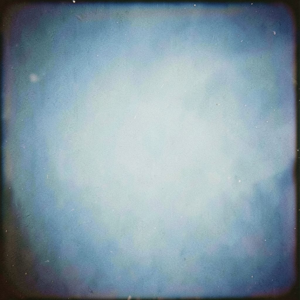 A soft analog film photo in pale cream and dusty blue, grainy and tranquil.